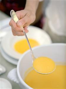 A Person Serving Butternut Squash Soup