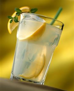 Home-made lemonade in glass with lemon wedges