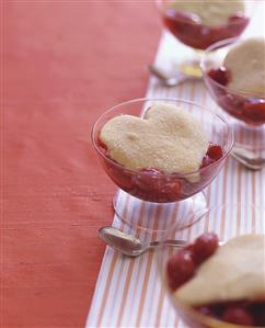 Cherry dessert with heart-shaped biscuit