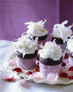 Mini Chocolate Cupcakes with White Icing and Toasted Coconut Shavings; Rose Petals