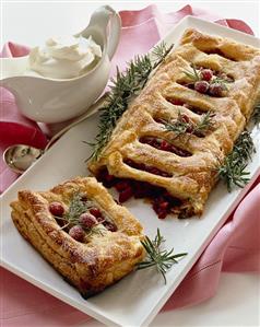 Cranberry Strudel Broken on a Platter; Pitcher of Whipped Cream