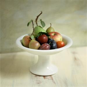 Fruit bowl with apples, pears and plums