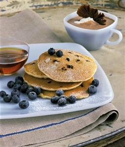 Pancakes with blueberries, maple syrup, chocolate drink