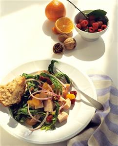 Spinach salad with ham, mandarins and raspberries