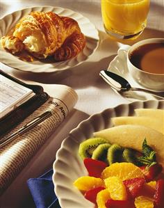 Continental Breakfast of Fruit, Croissant, Coffee, and Orange Juice, with Newspaper and Organizer