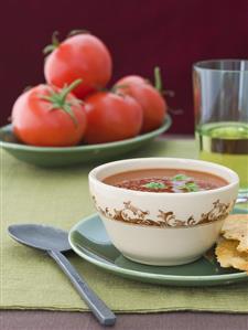 Bowl of Fresh Tomato Soup with Fresh Tomatoes in Background