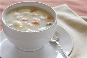 A Bowl of Potato Soup with Carrots