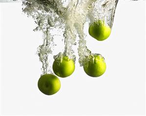 Green Apples Splashing into Water