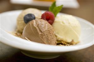 Assorted Scoops of Ice Cream with Berries in a Bowl