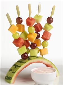 Fruit Skewers Stuck in Watermelon Rind Holder; Raspberry Yogurt Dip