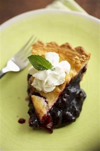 Slice of Blueberry Pie on a Green Plate; Fork