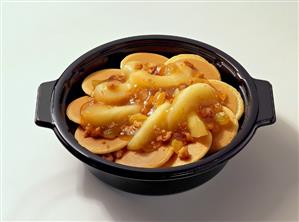 Pancakes with Apple Slices in Black Bowl