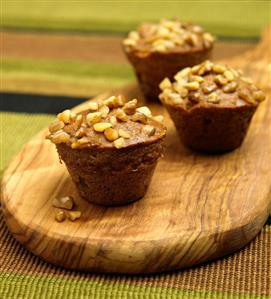 Three Banana Nut Muffins on a Cutting Board