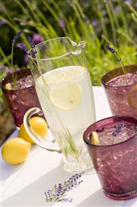 Pitcher and Glasses of Lavender Lemonade on an Outdoor Table