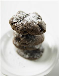 Chocolate Cookies with Powdered Sugar Stacked on a Plate