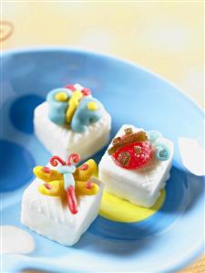 Three Mascarpone Petit Fours Decorated with Candy Insects