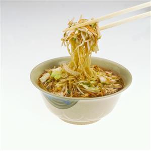 Chopsticks Removing Noodles and Vegetables From Soup Bowl, White Background