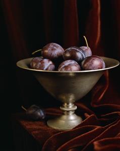 Fresh Plums in a Metal Pedestal Fruit Bowl