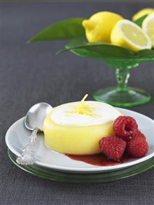 Lemon blancmange with fruit sauce and raspberries