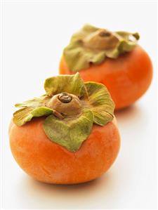 Two Persimmons on a White Background