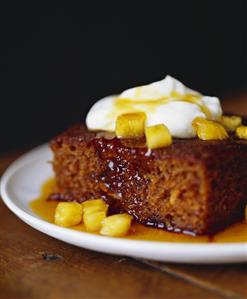 Piece of Cake with Pineapple Sauce and Whipped Cream