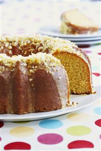 An Iced Orange Bundt Cake with Slice Removed