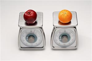 Two Scales; One with an Apple and One with an Orange