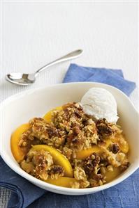 Bowl of Peach Crisp with Vanilla Ice Cream