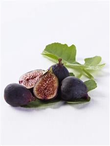 Fresh Figs on Leaves; One Halved