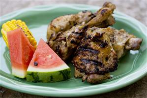 Grilled Chicken Pieces with Watermelon and Corn on the Cob