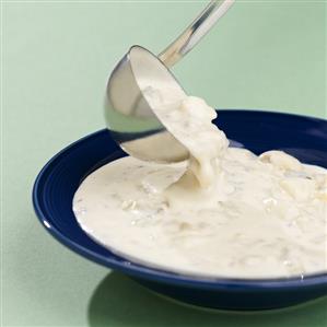 Ladling Clam Chowder into Blue Bowl