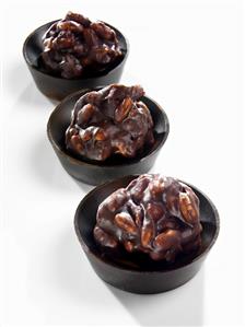 Three Chocolate Orange Crunch Truffles on Wooden Ramekins