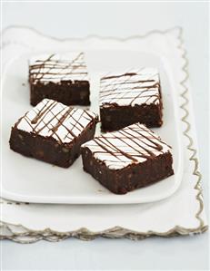 Four Frosted Mississippi Mud Brownies on a Plate