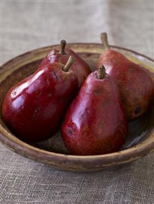 Four Red Pears in Wooden Bowl