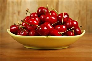 Fresh Red Cherries in a Green Dish