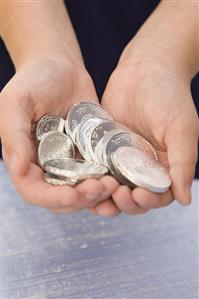 Childs Hands Holding Silver Chocolate Gelt; Chanukah Coins