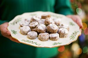 Woman Holding Plate of Chocolate Cookies