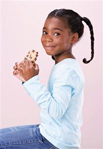 Little Girl Holding Bitten Chocolate Chip Cookie