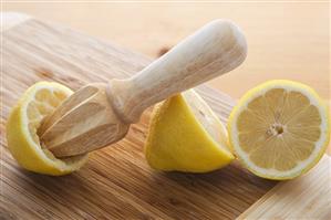 Wooden Juicer in Lemon Half; Halved Lemon