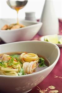 Bowls of Asian Shrimp and Linguini Soup with Spinach