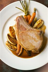 Roasted Pork Chop with Caramelized Carrots, Parsnips and Apples