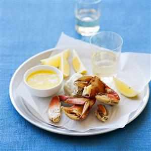 Cracked Crab Legs with Melted Butter and Lemon Wedges