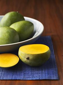 Sliced Mango with Bowl of Whole Mangos