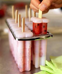 Removing Homemade Watermelon Sorbet Popsicle from Mold