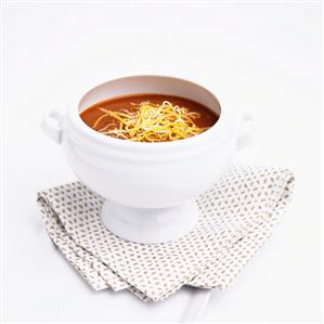 Bowl of Tomato Soup Topped with Shredded Cheese