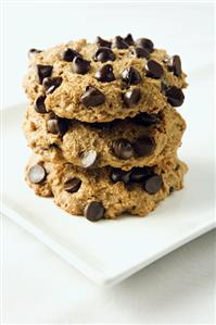 Three Chocolate Chip Cookies Stacked on a White Plate