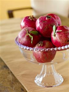 Pomegranates in a Glass Pedestal Bowl