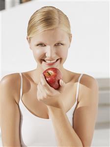 Woman with red apple outdoors