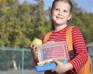 A student outside of school eating