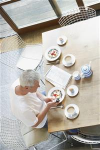 Man at breakfast with a mobile phone